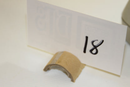 Number 18 label and cardboard piece as photographed