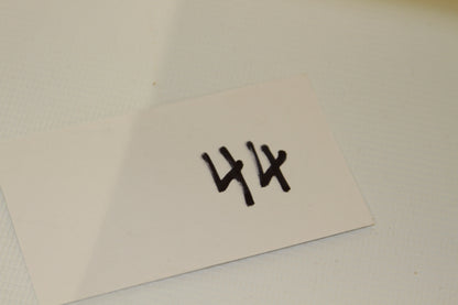 White card with number 44 written in black marker