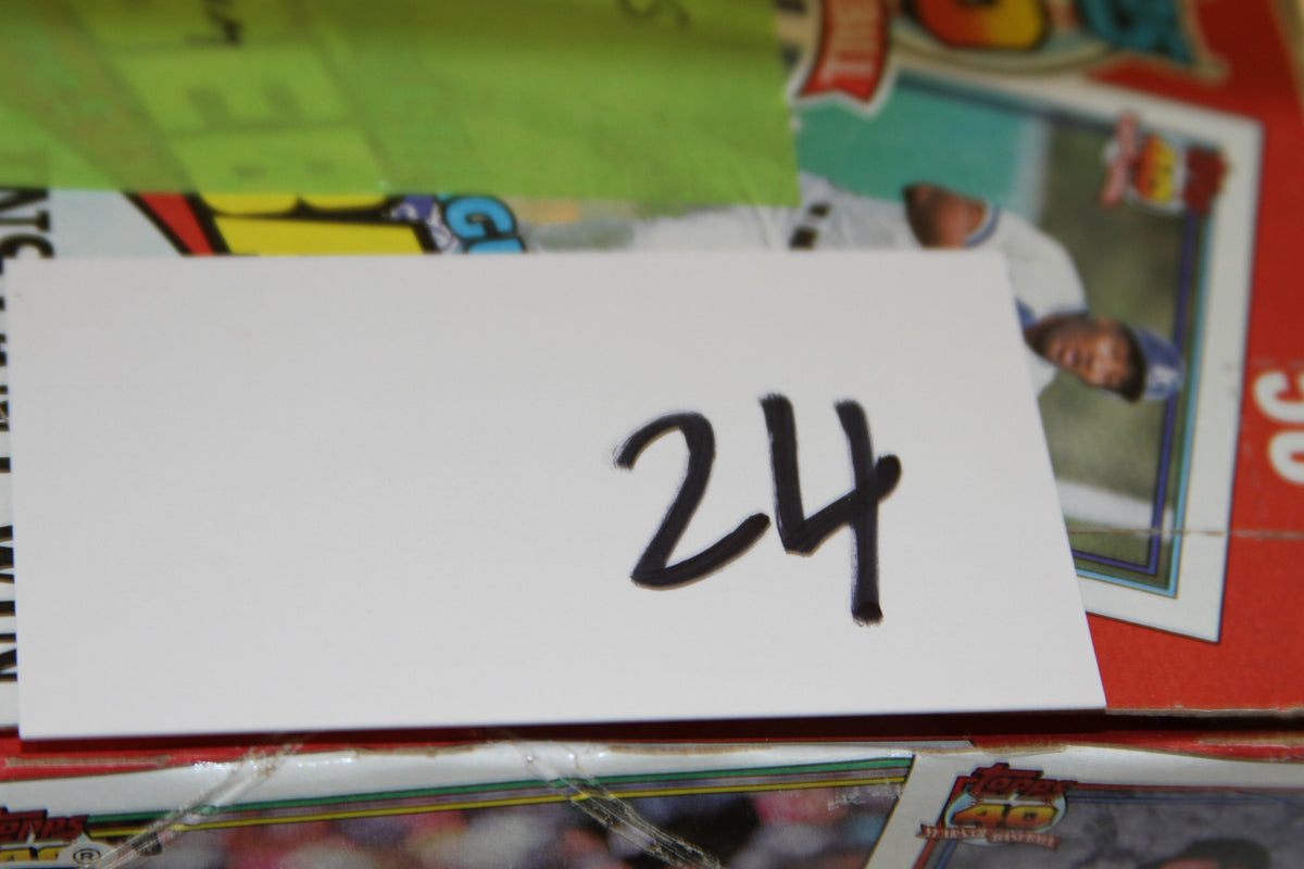 Close-up of handwritten number 24 on card atop the 1991 Topps Baseball box