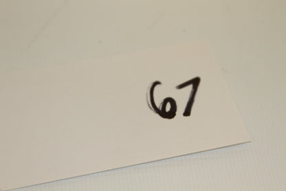 White card with handwritten number 67
