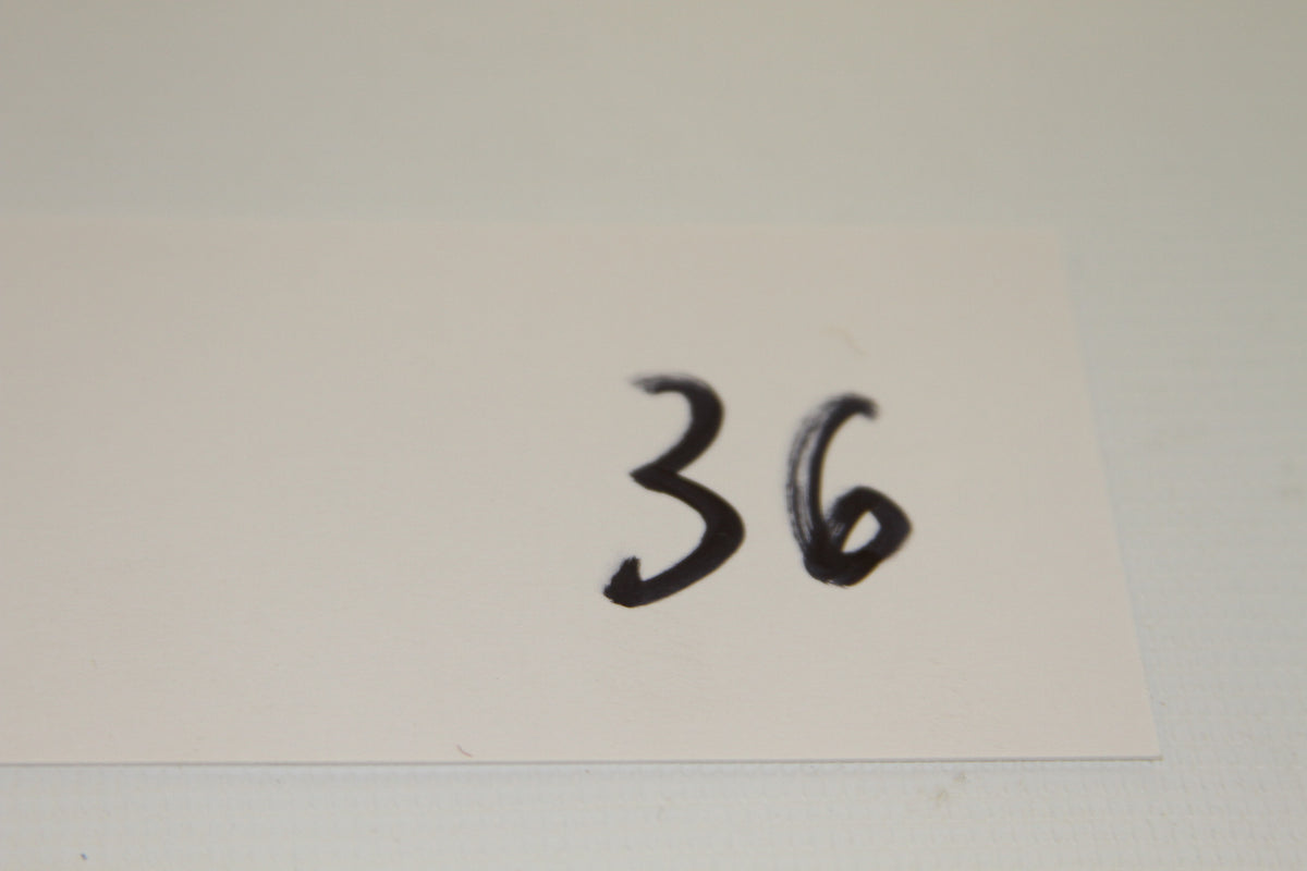 White card with the handwritten number 36