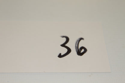 White card with the handwritten number 36