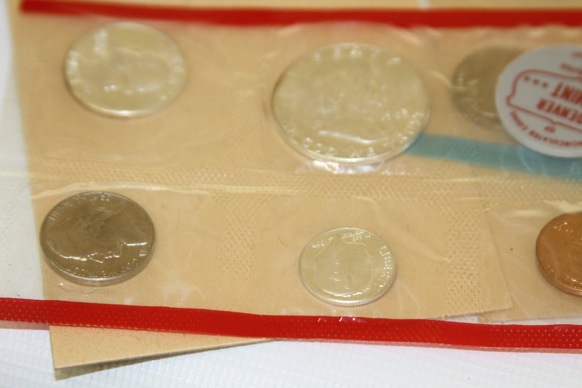 Detailed view of 1963 uncirculated coins in red and blue sealed holders