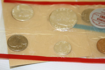 Detailed view of 1963 uncirculated coins in red and blue sealed holders