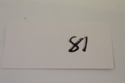 Index card labeled 81 near the coin set