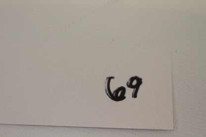 Handwritten label with number 69 on white card