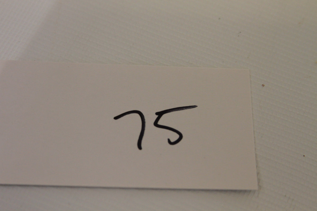 White card with handwritten number 75