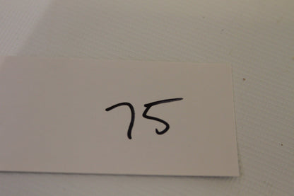 White card with handwritten number 75