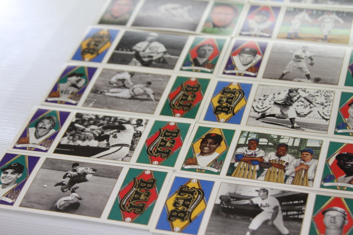 Classic player cards and action moments on uncut baseball card sheet