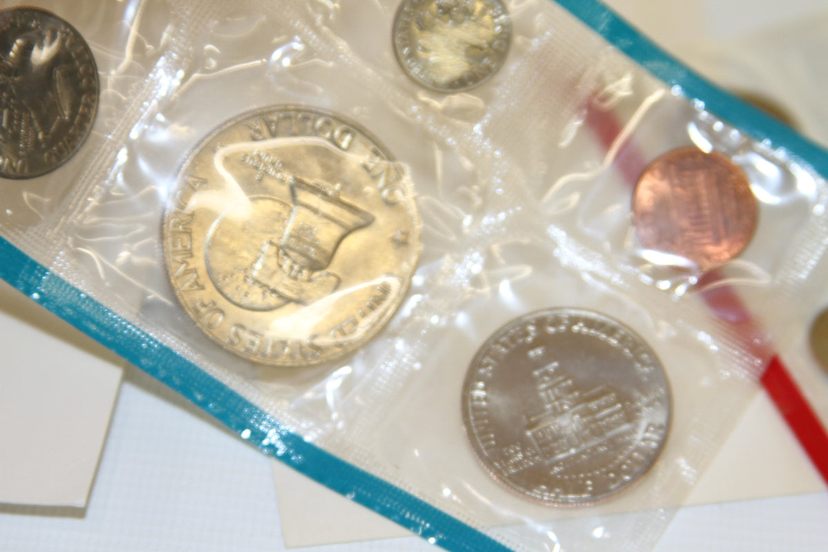 Reverse side of Bicentennial dollar, penny, and Montgomery quarter in blue sleeve