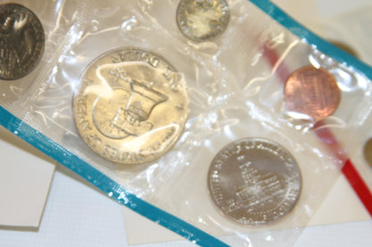 Reverse side of Bicentennial dollar, penny, and Montgomery quarter in blue sleeve