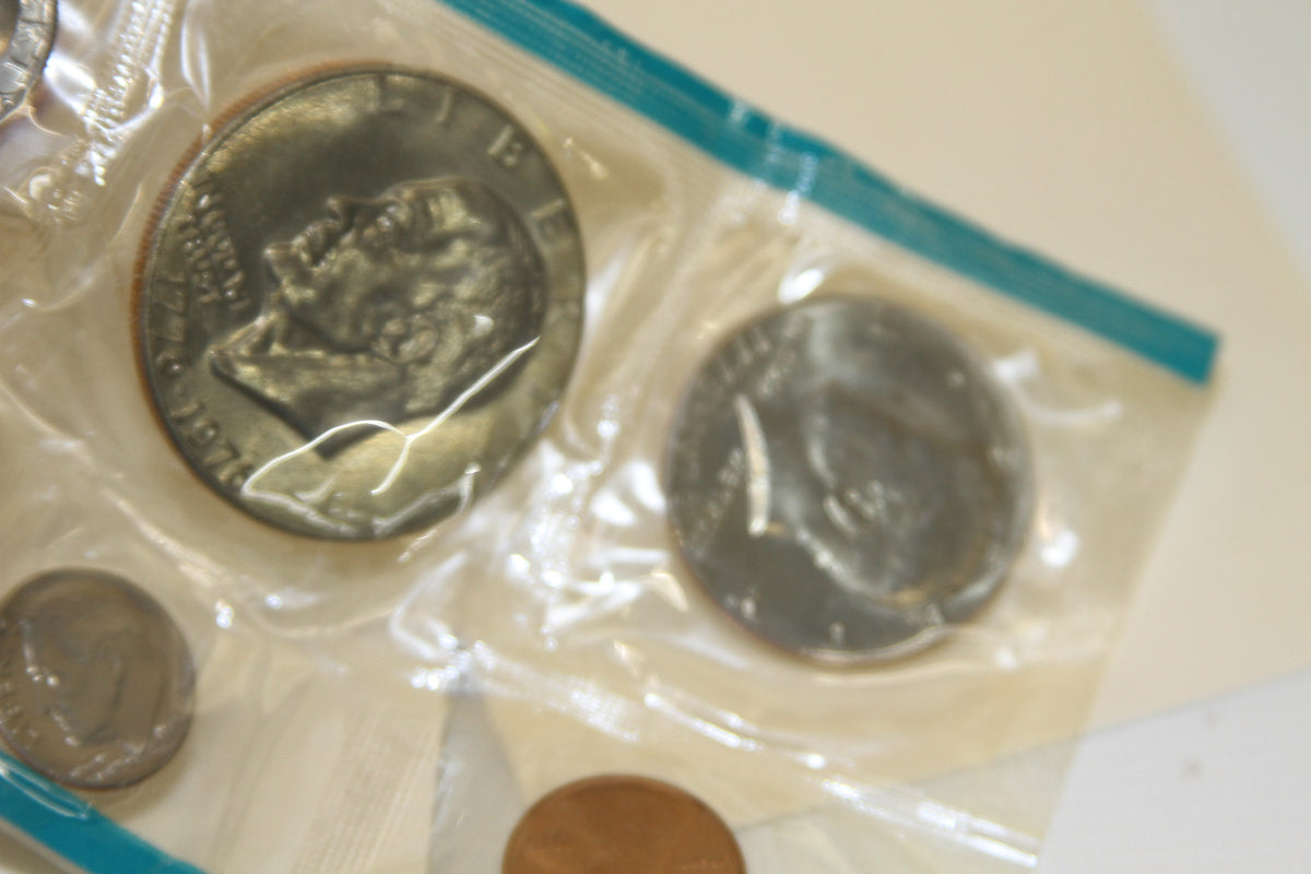 Head side and various coins close-up from 1975 U.S. Mint Set in protective plastic