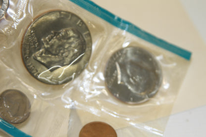 Head side and various coins close-up from 1975 U.S. Mint Set in protective plastic