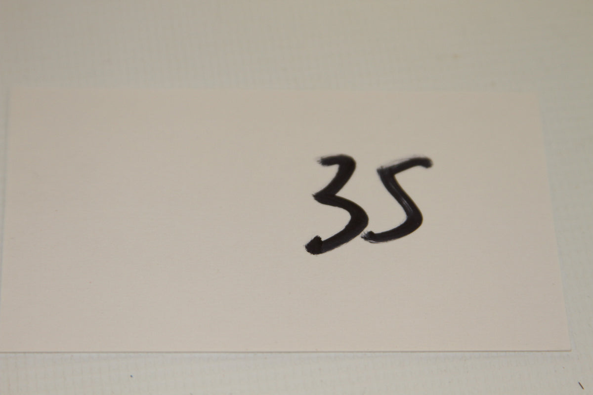White card with the number 35 written in black marker