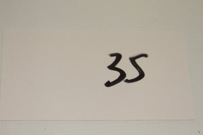 White card with the number 35 written in black marker