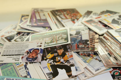 Close-up of a pile of trading cards, featuring a Pittsburgh Penguins player and assorted card backs.