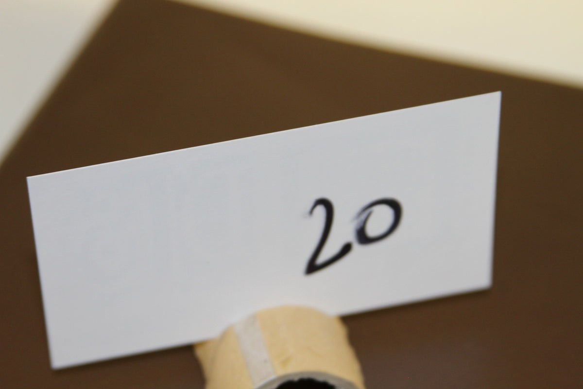 Card displaying the number 20 on brown background