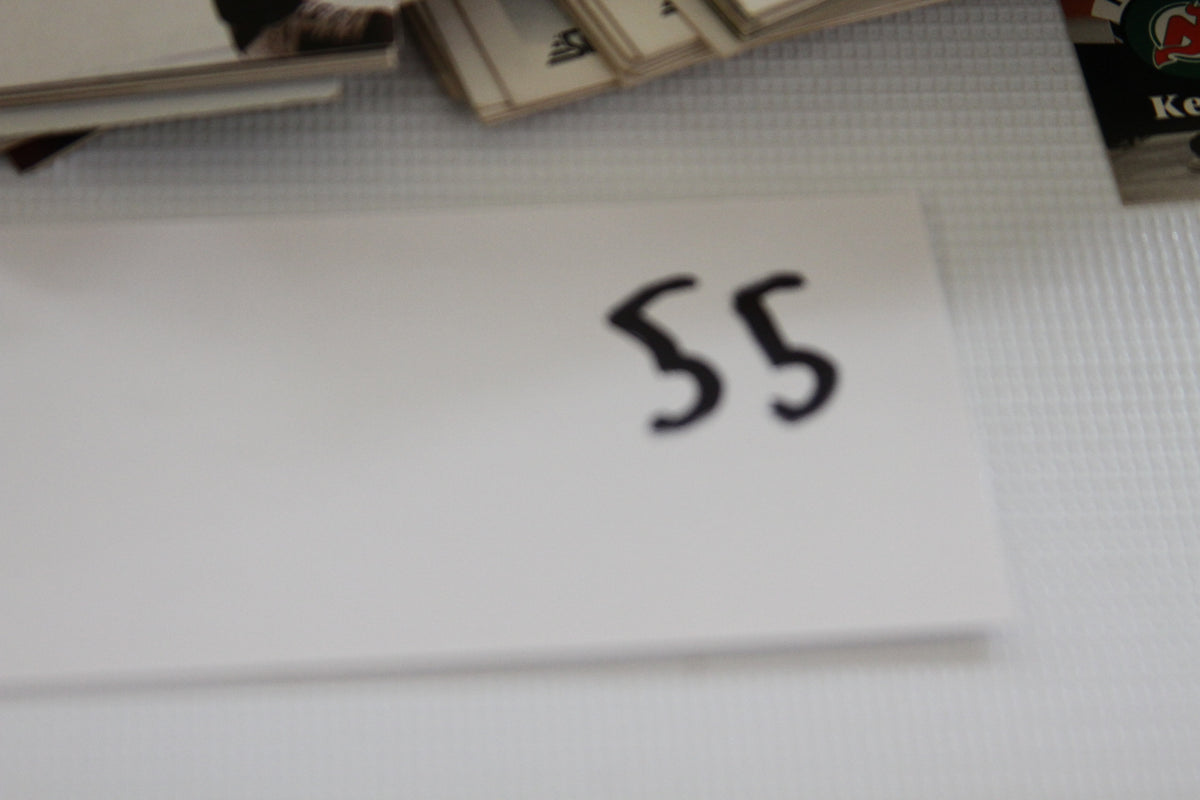 White paper card labeled '55' on a white background.